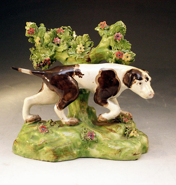 ANTIQUE STAFFORDSHIRE POTTERY FIGURE OF DOG WITH BOCAGE
