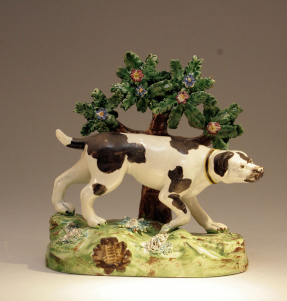 ANTIQUE STAFFORDSHIRE POTTERY FIGURE OF A SPORTING DOG WITH BOCAGE