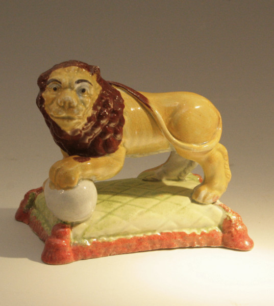 Antique Staffordshire pottery standing lion on base..... early 19thc