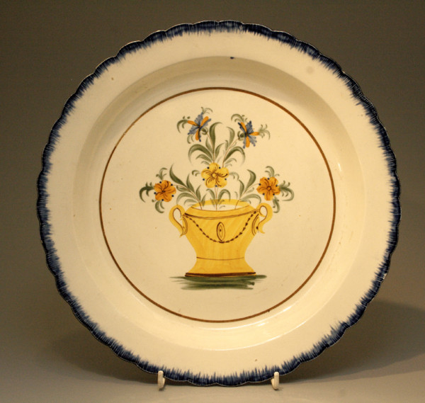 Antique pottery Pearlware Charger with basket of flowers in center panel.