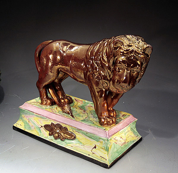 ANTIQUE POTTERY FIGURE OF NERO THE LION IN LUSTRE