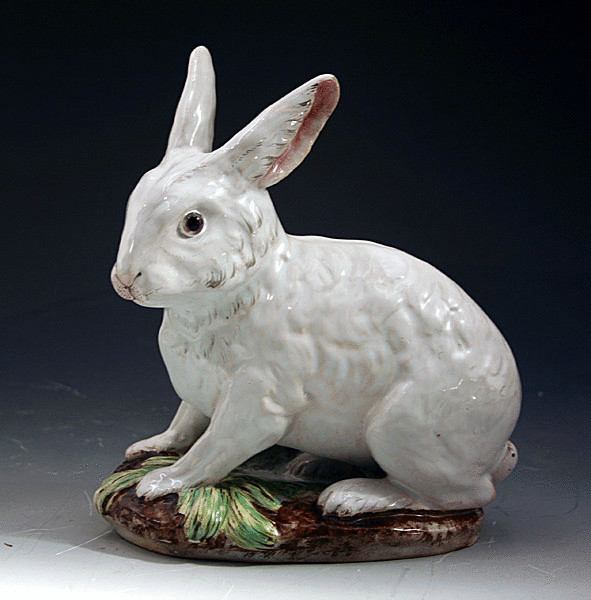 GALLE POTTERY FIGURE OF A RABBIT WITH GLASS EYES.