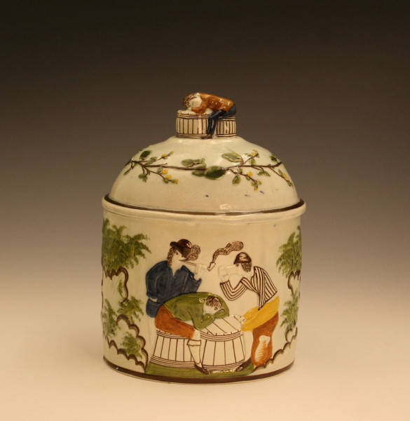 Prattware pottery tobacco box or jar with relief moulded decoration.