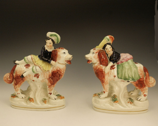 Staffordshire pottery figures of Children riding Dogs