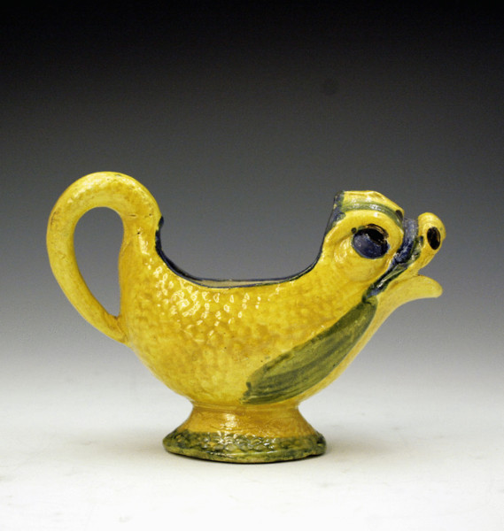 Staffordshire pearware sauce boat in the form of a figure of a dolphin
