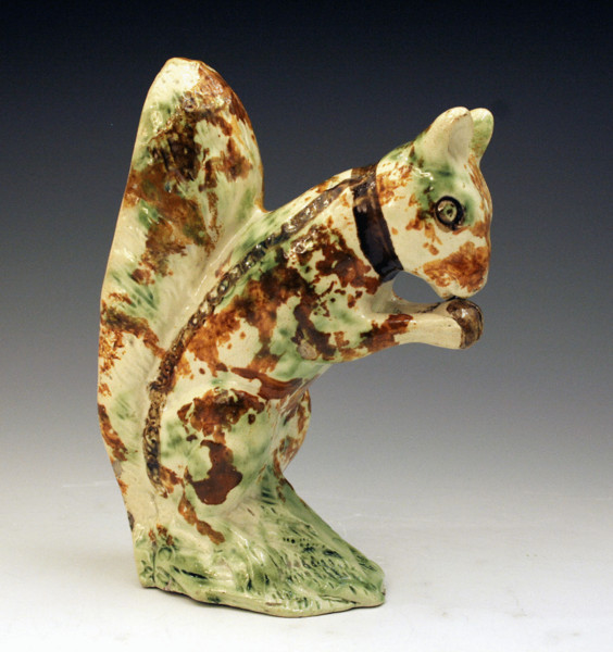 STAFFORDSHIRE  POTTERY FIGURE OF SQUIRRELL IN UNDERGLAZE COLOURS