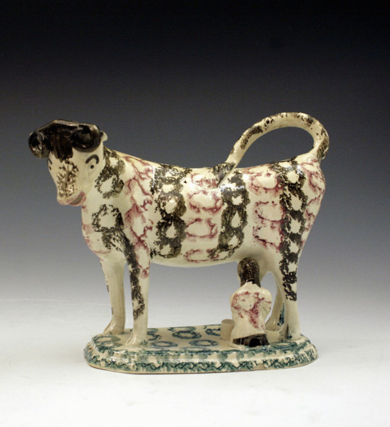 Figure of an early 19thc cow creamer on base.