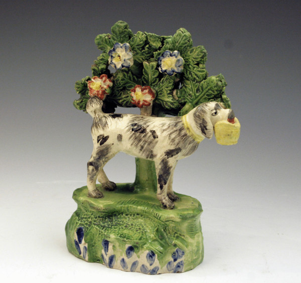 STAFFORDSHIRE FIGURE OF A DOG HOLDING A BAG IN HIS MOUTH