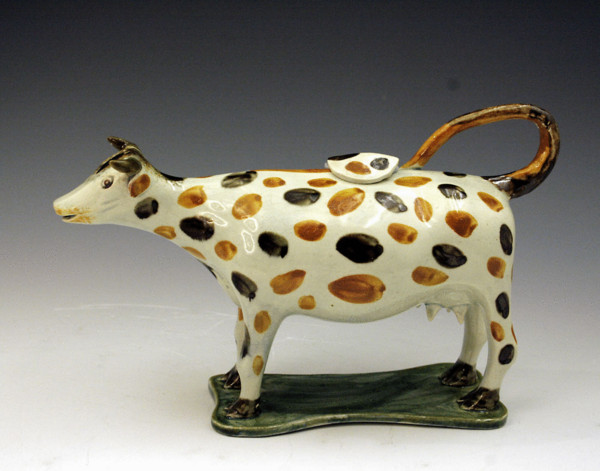 Prattware figure of a cow on base in the form of a creamer
