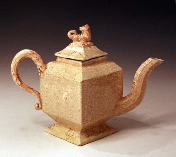 Early English creamware pottery teapot with variagated clay decoration. 18thc