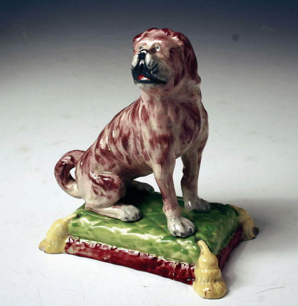 STAFFORDSHIRE POTTERY DOG ON CUSHION FIGURE C1820