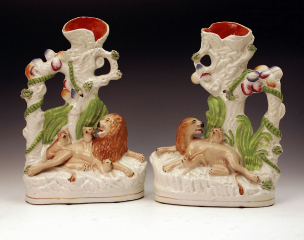 Pair of Victorian Staffordshire pottery figures of lions with cubs.