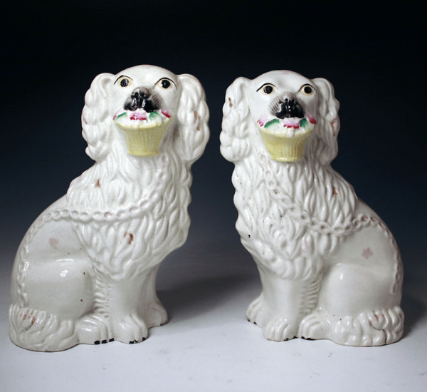 Pair antique figures of Staffordshire pottery dogs with baskets