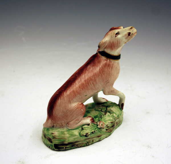 sTAFFORDSHIRE POTTERY PEARLWARE FIGURE OF A SEATED DOG 
