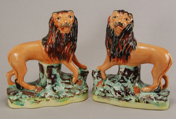 Pair of Staffordshire pottery figures of standing lions from  Staffordshire.