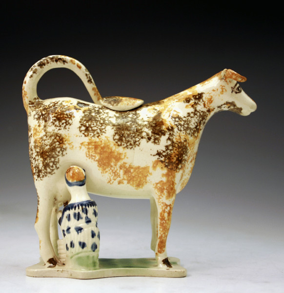 Antique English pottery Prattware cow creamer with milk maid. circa 1810