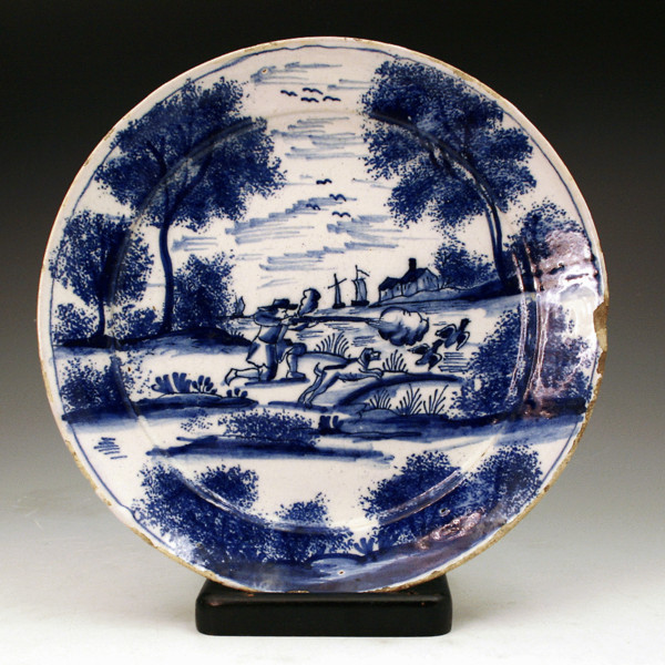 English London delftware plate  profusely decorated with a rural hunting scene