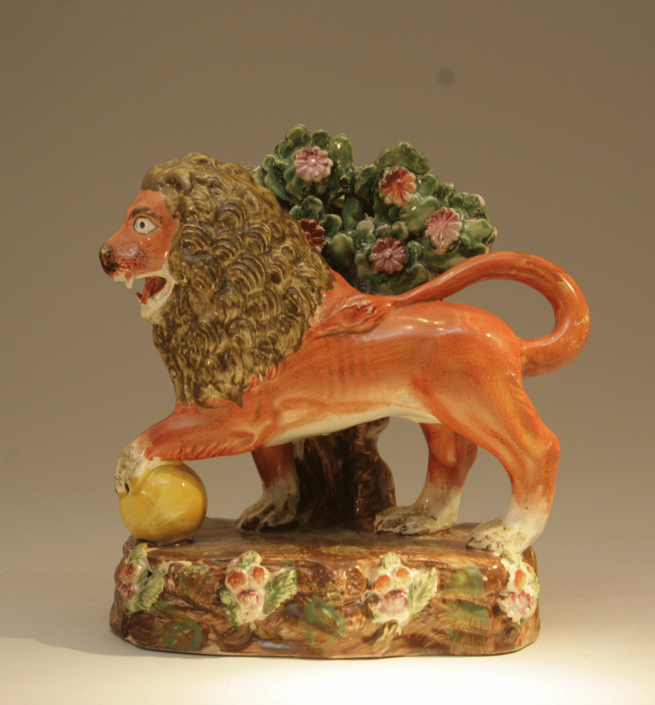 ANTIQUE STAFFORDSHIRE POTTERY FIGURE OF A LION WITH BOCAGE