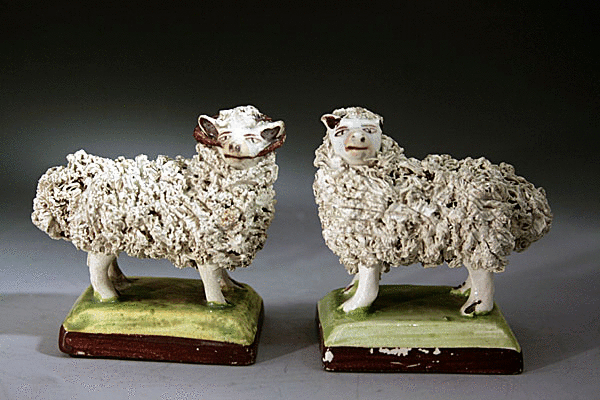 Pair of English pottery figures of a ram and ewe