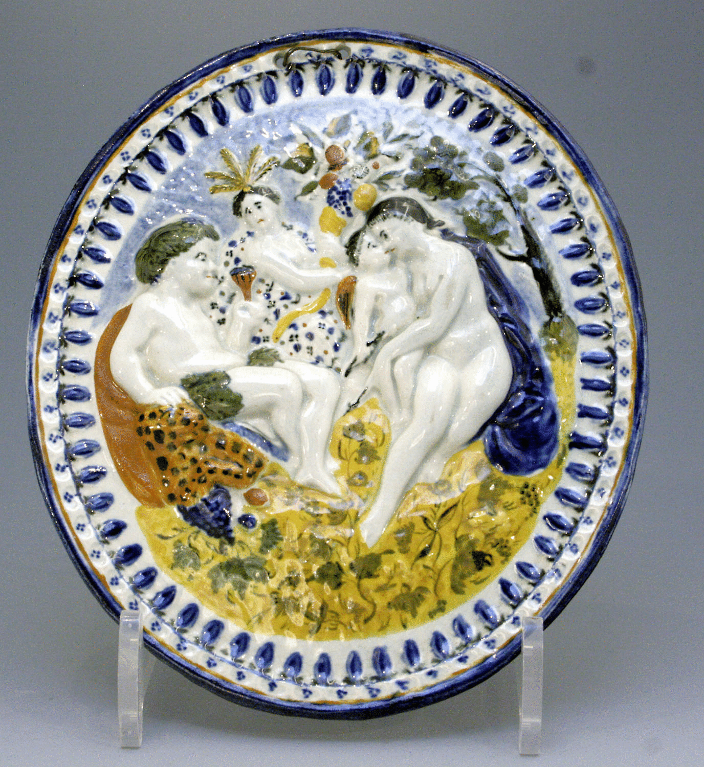 Prattware pottery plaque with classical scene in relief 