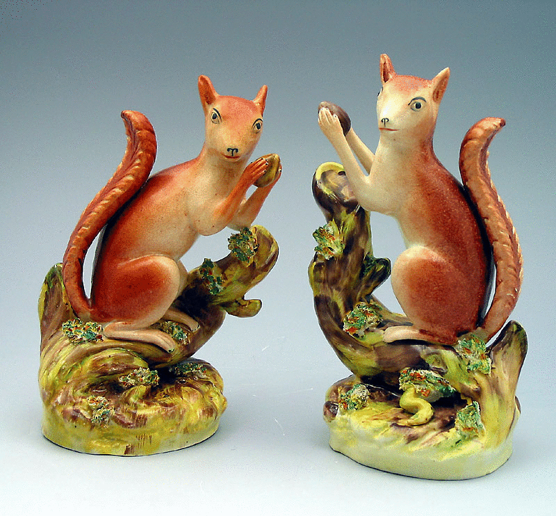 Pair Staffordshire pottery figures of Squirrels eating nuts. c1850