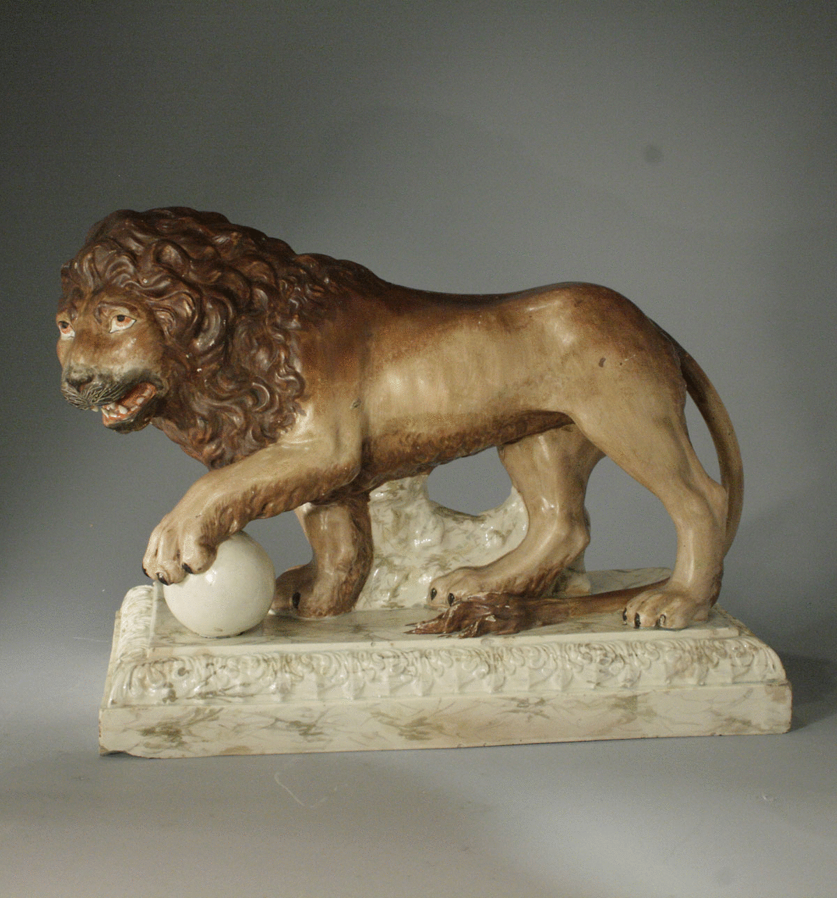 Staffordshire pottery figure of a lion standing on base