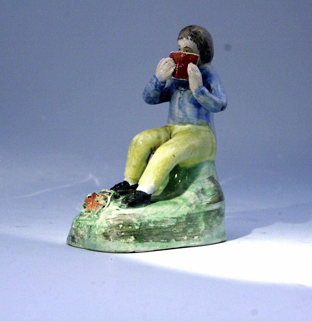 Staffordshire figure of a reading boy