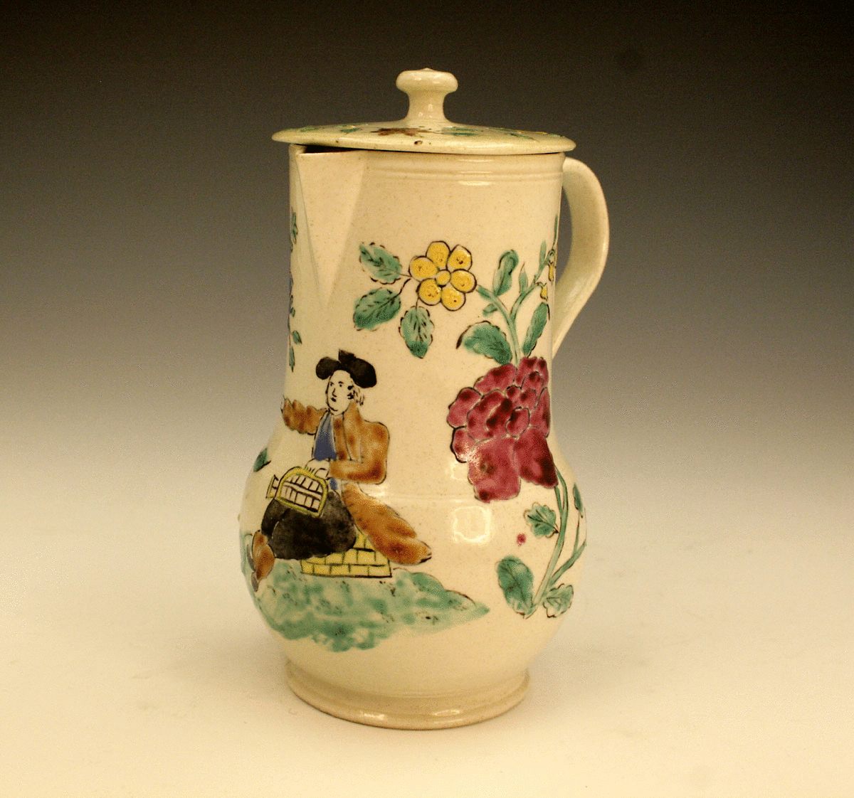 Saltglaze lidded pot with enamel decoration of a male figure.