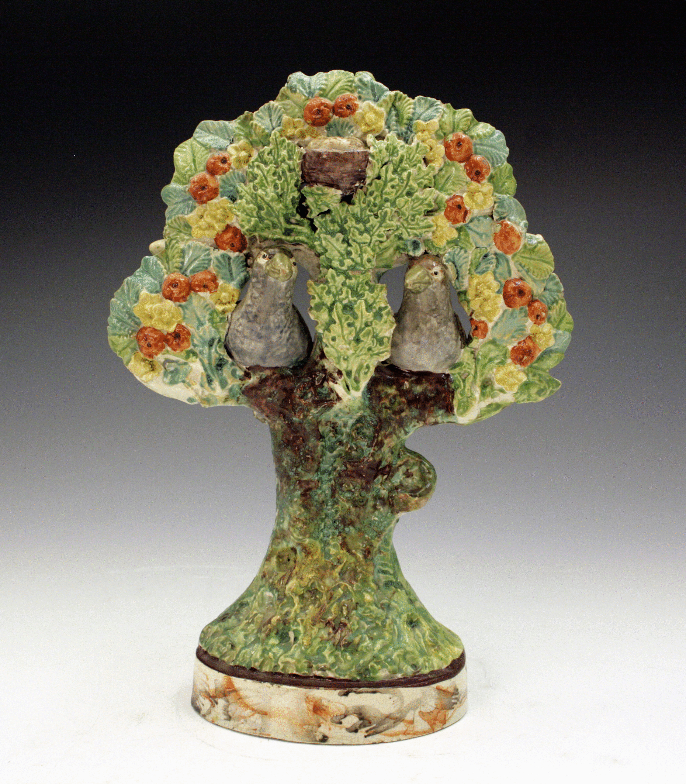 Staffordshire figure group with bocage and birds in branches