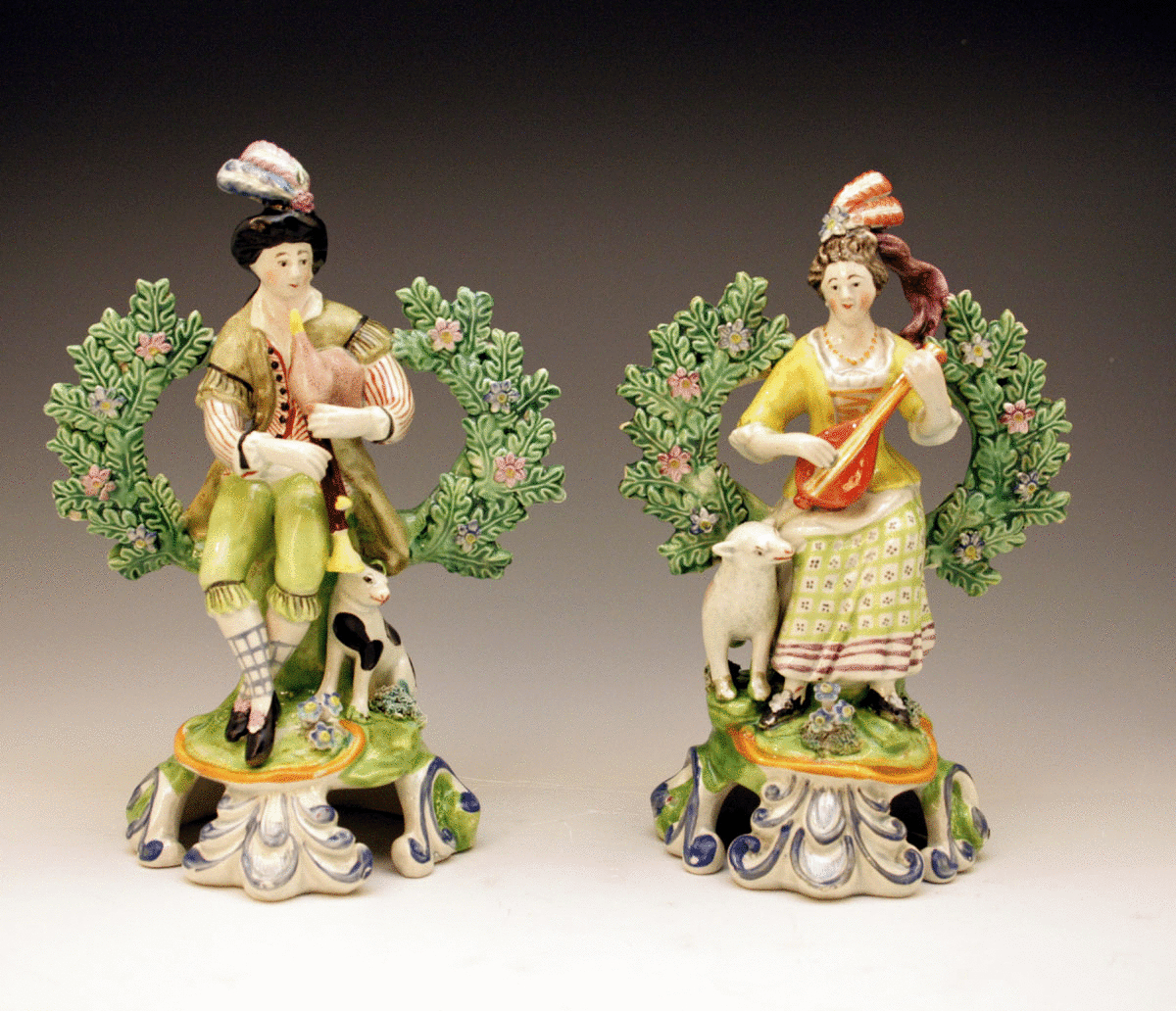 Pair Staffordshire pottery pearlware figures of musicians with bocage
