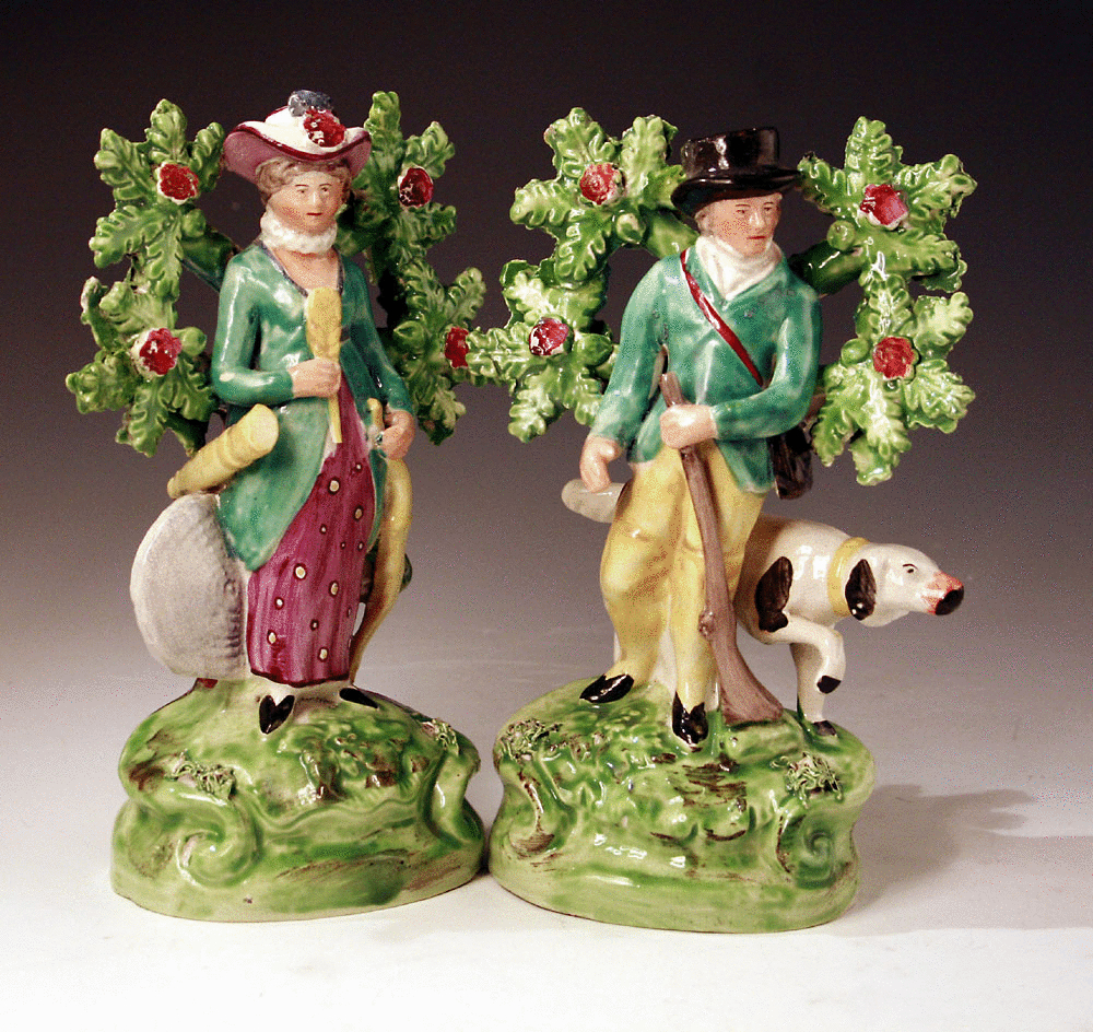 Pair of Staffordshire pottery figures of an archer and sportsman with bocage.
