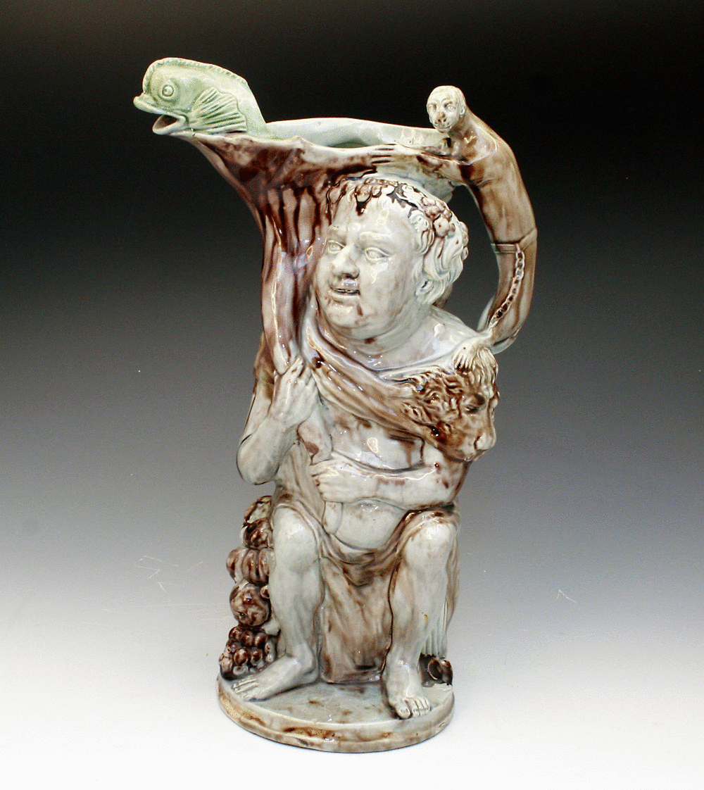 BACCHUS RELIEIF MOULDED STAFFORDSHIRE POTTERY JUG WITH COLOURED GLAZES  