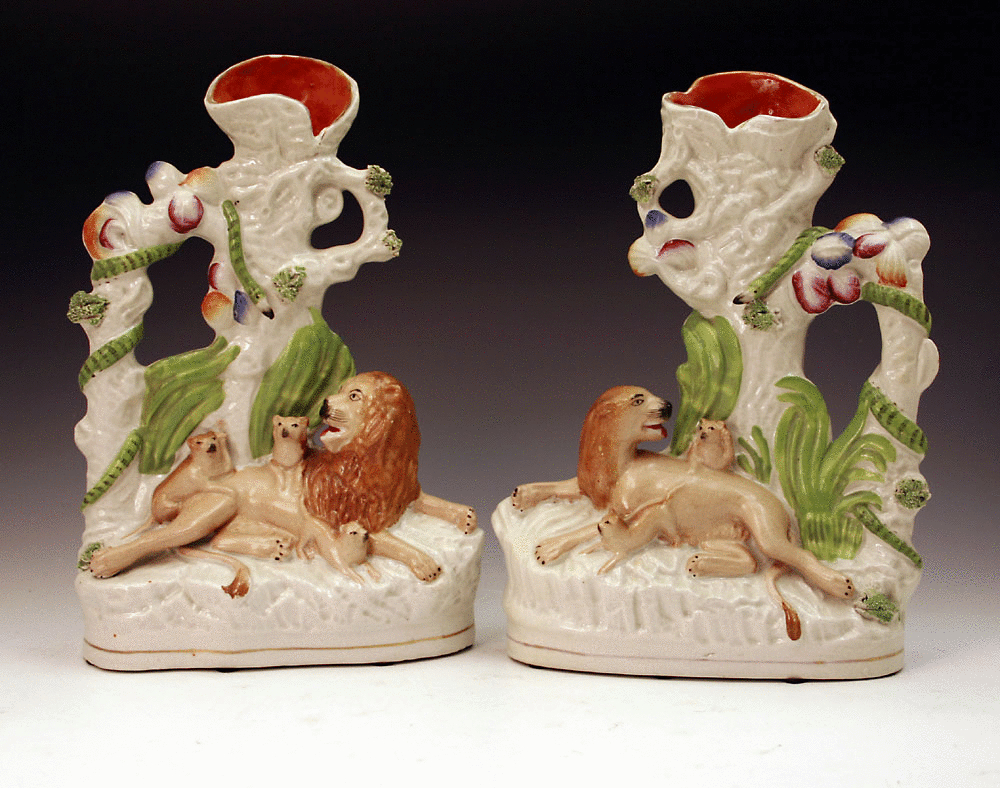 Pair of Victorian Staffordshire pottery figures of lions with cubs.