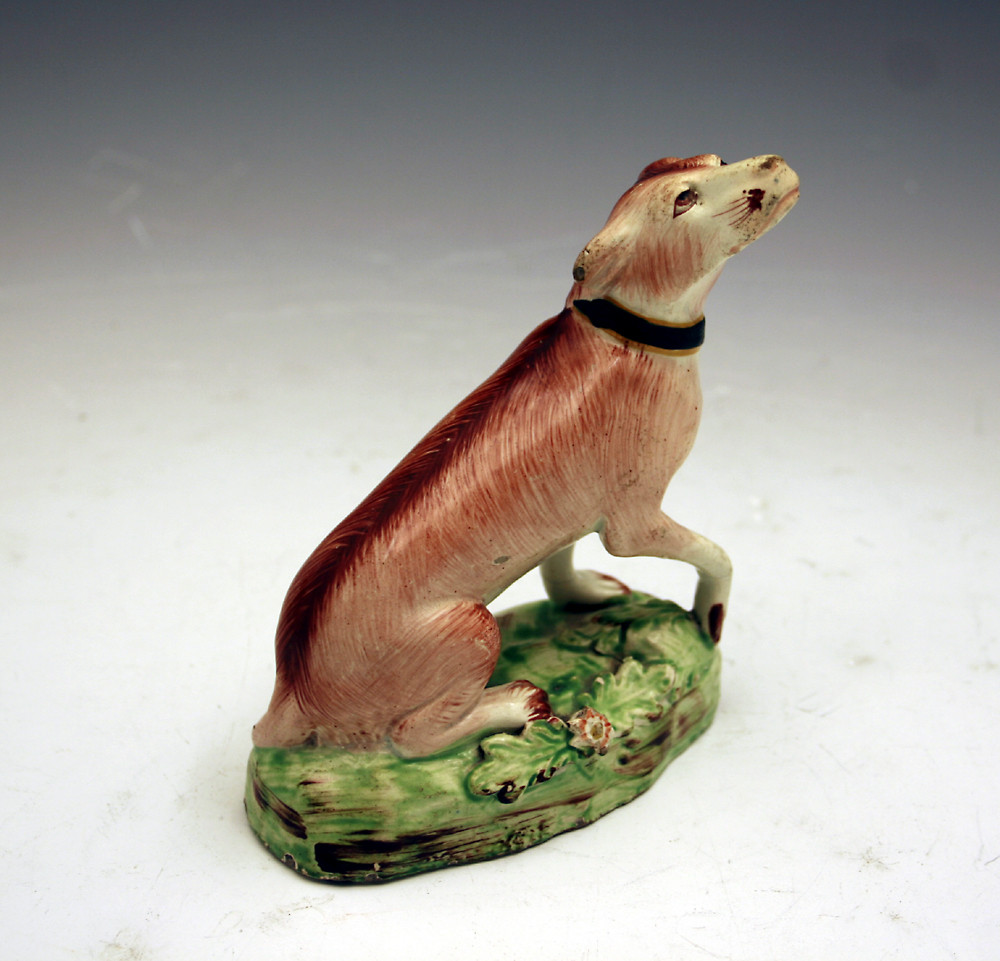 sTAFFORDSHIRE POTTERY PEARLWARE FIGURE OF A SEATED DOG 