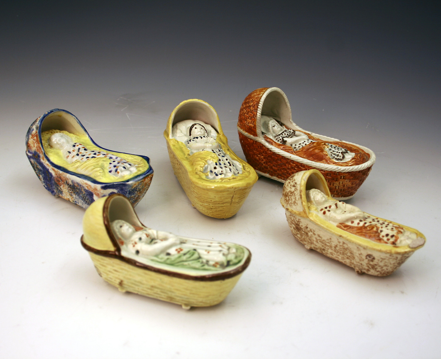 STAFFORDSHIRE POTTERY CRADLES WITH FIGURE OF BABY C1800/20