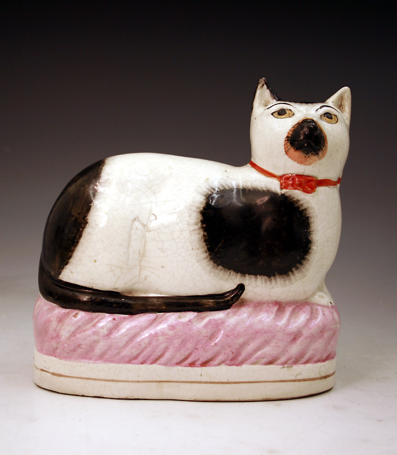 Victorian Staffordshire pottery figure of a recumbant cat mid 19thc.