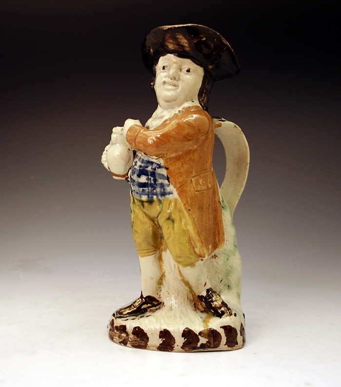 English pottery Toby Jug in Pratt colours .