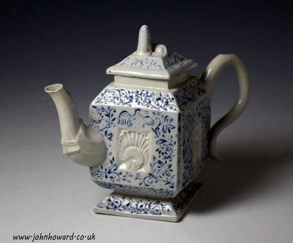 Antique Staffordshire pottery saltglaze teapot relief decorated in blue with shells foliage and birds mid 18th century
