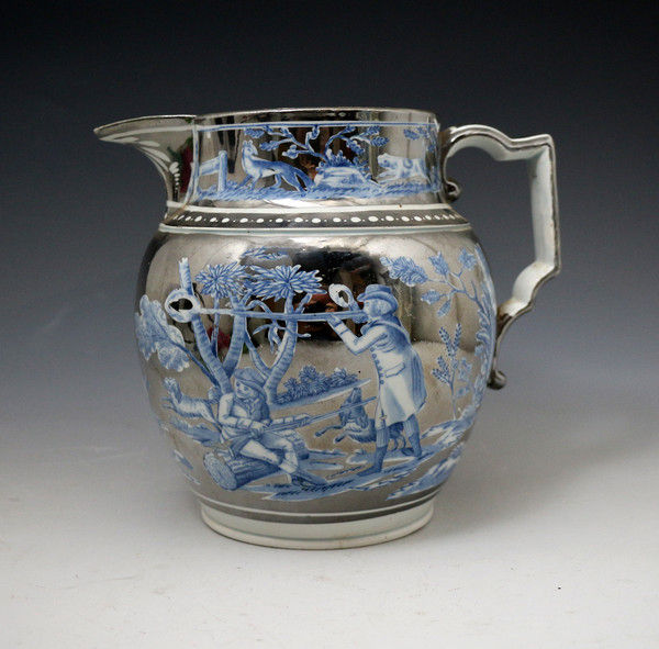 Antique silver luster pottery pitcher with underglaze blue decoration.