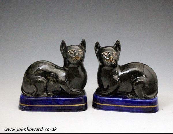Antique Staffordshire pottery black cats on blue bases mid 19th century England.
