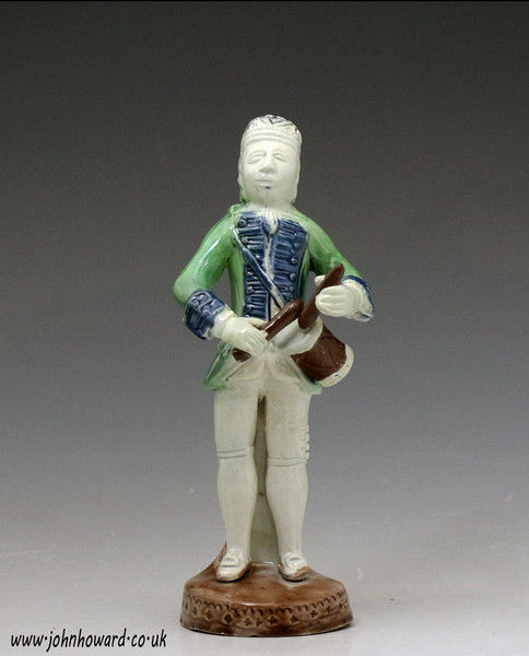 Antique mid 18th century figure of a drummer boy in the Whieldon fashion.