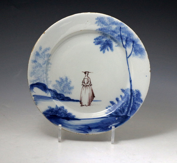 English delftware plate decoarted with figure of a lady in landscape circa 1760 London