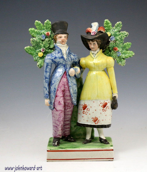 Staffordshire figure group of The Dandies, pearlware pottery with bocage early 19th century.