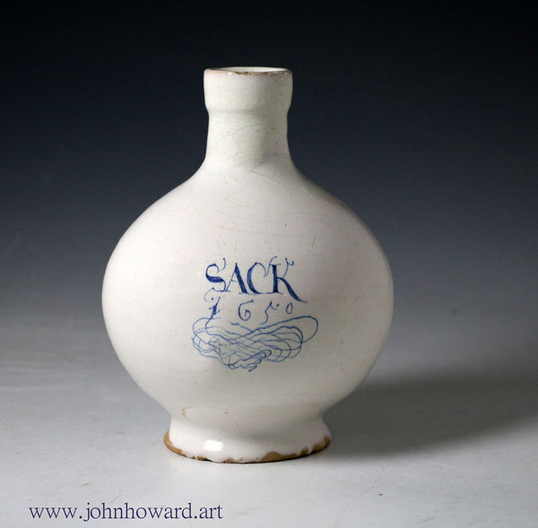 English delft wine bottle white glaze titled Sack and dated 1650 with an elaborate scroll