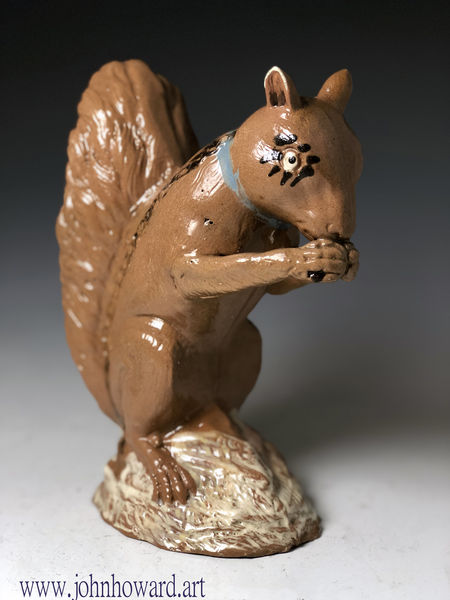 Staffordshire pottery figure of a seated squirrel nibbling a nut ...circa 1775 English