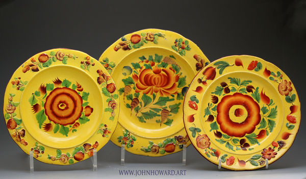 Trio of antique pottery plates with canary yellow ground and enamel colours early 19th century