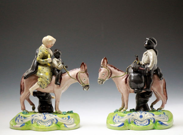 Pair Staffordshire pottery figures of chimney Sweep family riding mules.circa 1820