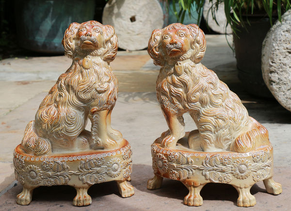 Pair of English saltglaze spaniels on oval bases. Briddon Pottery Derbyshire circa 1830