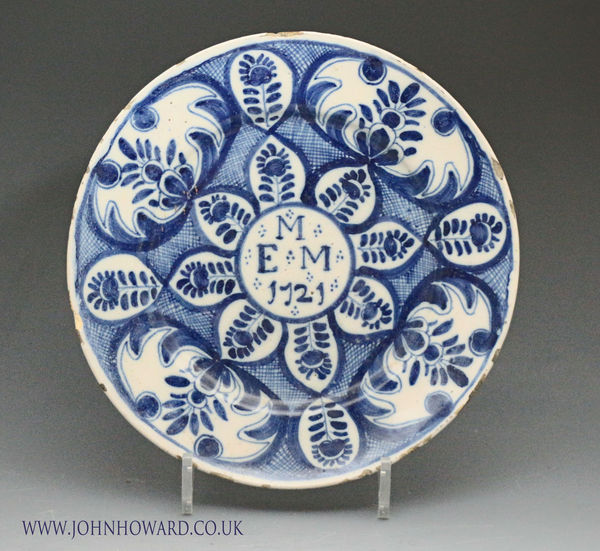 English delftware blue and white plate the central panel with initials M E M and date 1721