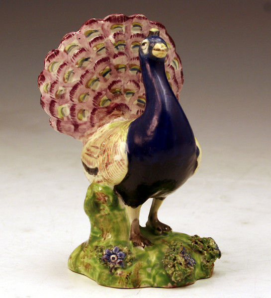 Staffordshire pottery figure of a peacock in bright enamel colours.c1820